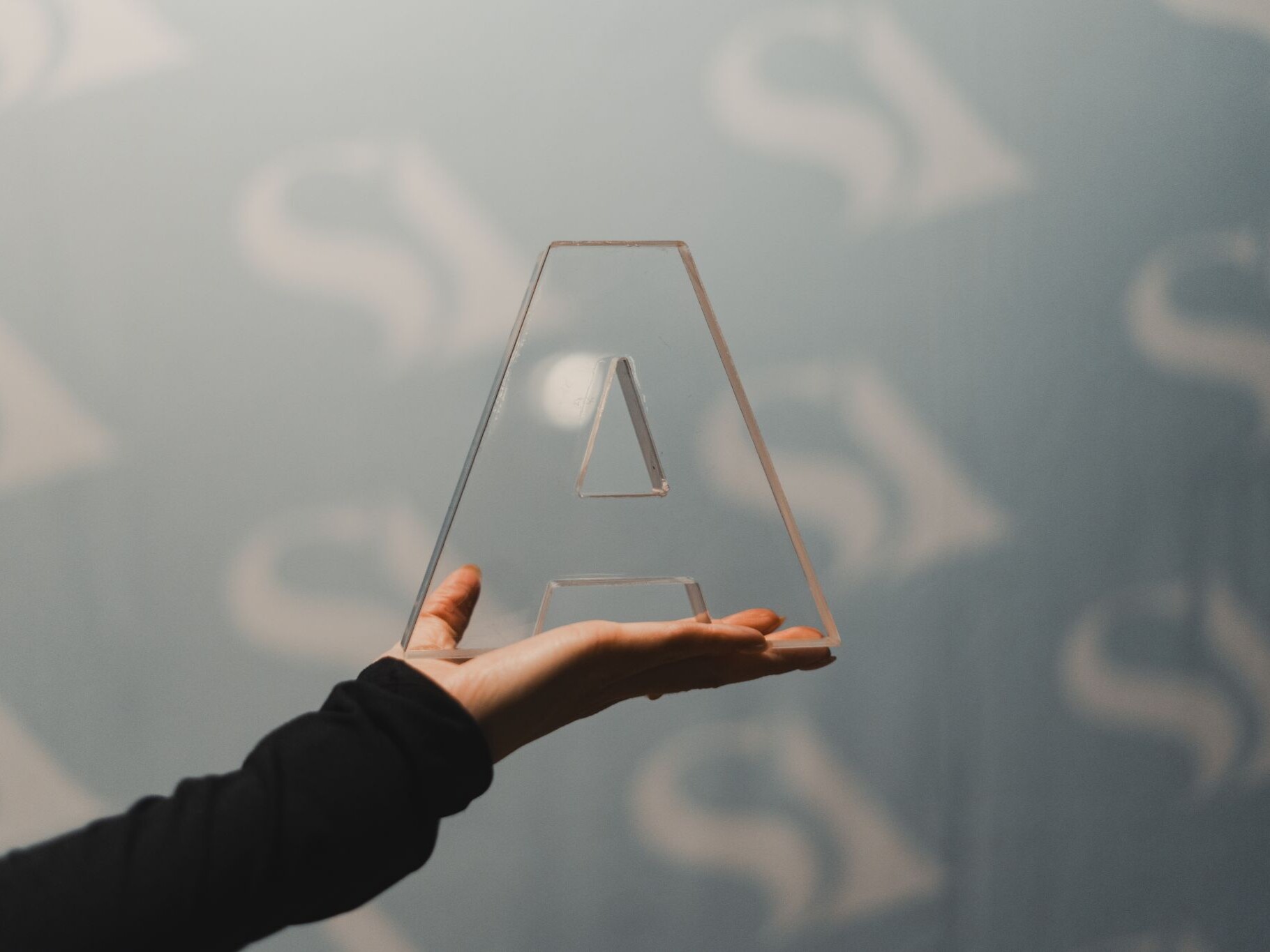 Hand holding A-shaped award