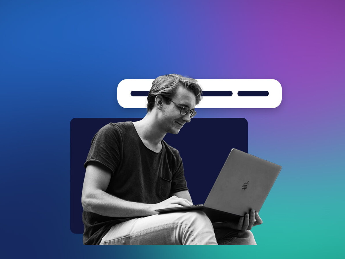 Young male on computer in front of gradient background