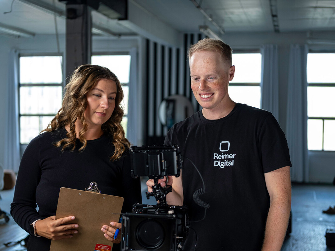 Man and woman look at camera on video shoot set